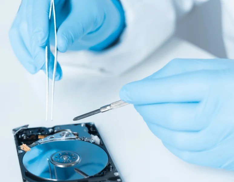 data recovery technician working on laptop hard drive